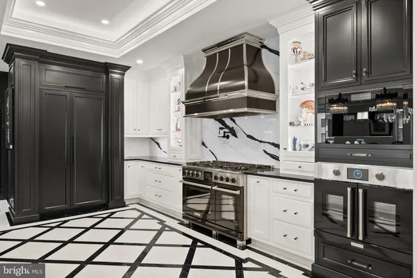 a stove top oven sitting inside of a kitchen