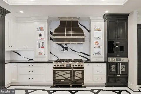 a kitchen with a sink appliances and cabinets