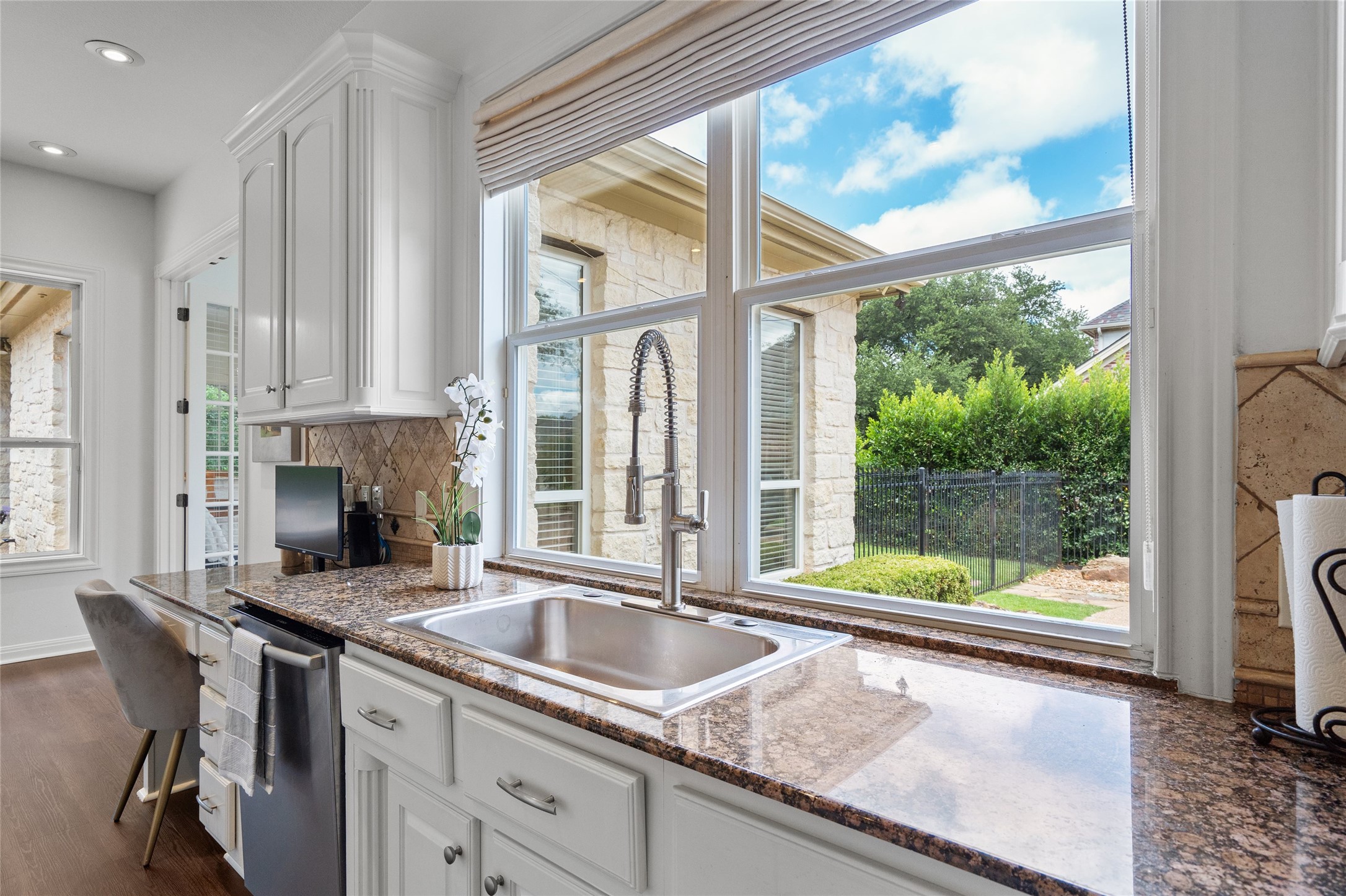 4313 Rio Robles Drive Austin, TX 78746 - Photo 14 of 40 A well-appointed kitchen features a large window above the sink, offering verdant views.
