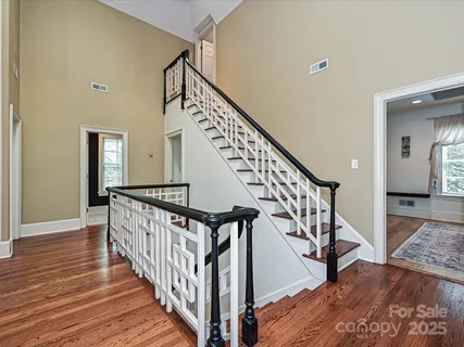 a view of staircase with wooden floor and a rug
