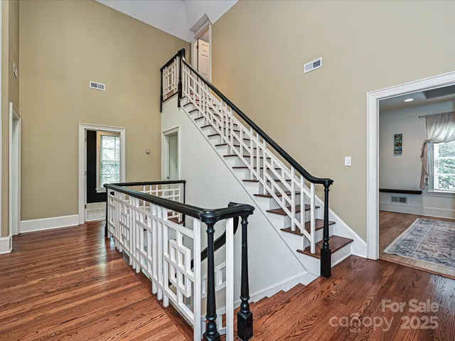 a view of staircase with wooden floor and a rug