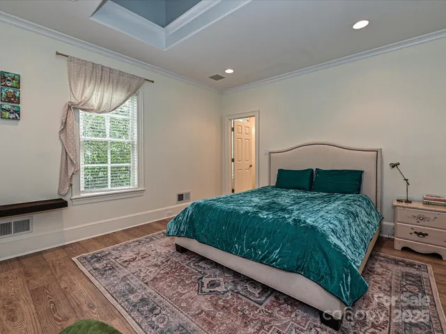 a bathroom with a granite countertop toilet sink and mirror