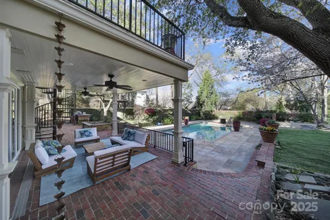 a view of a chairs and table in the backyard