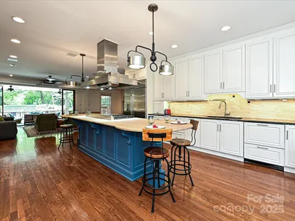 a kitchen with a sink cabinets and wooden floor