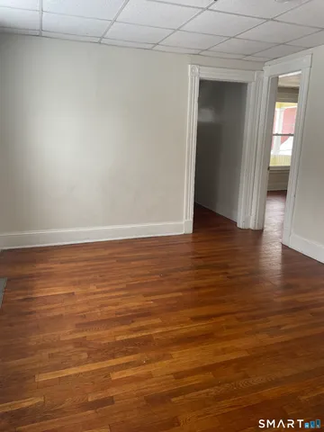 an empty room with wooden floor and closet