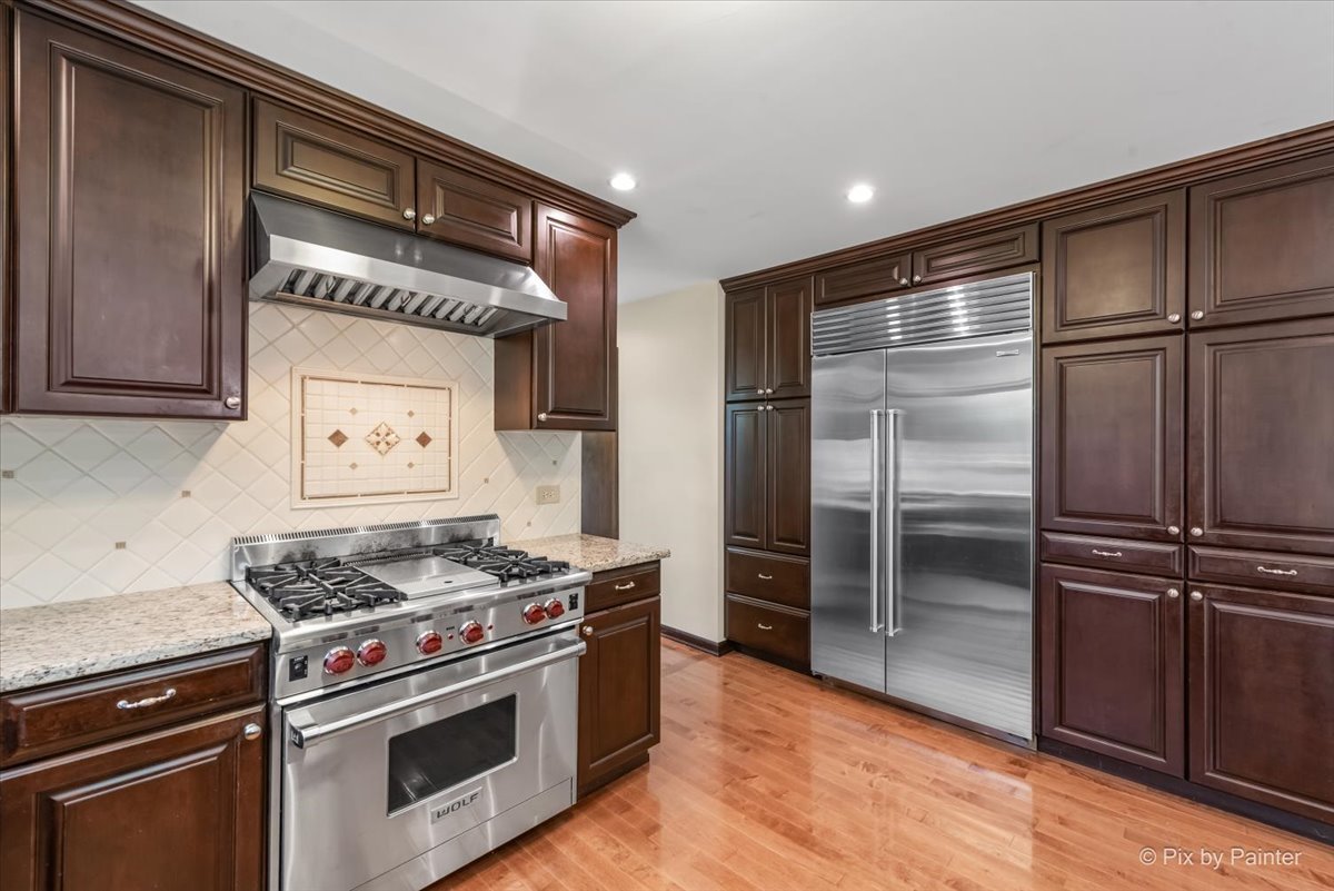 27W650 Mack Road Wheaton, IL 60189 - Photo 11 of 28 a kitchen with stainless steel appliances granite countertop a refrigerator and a stove top oven