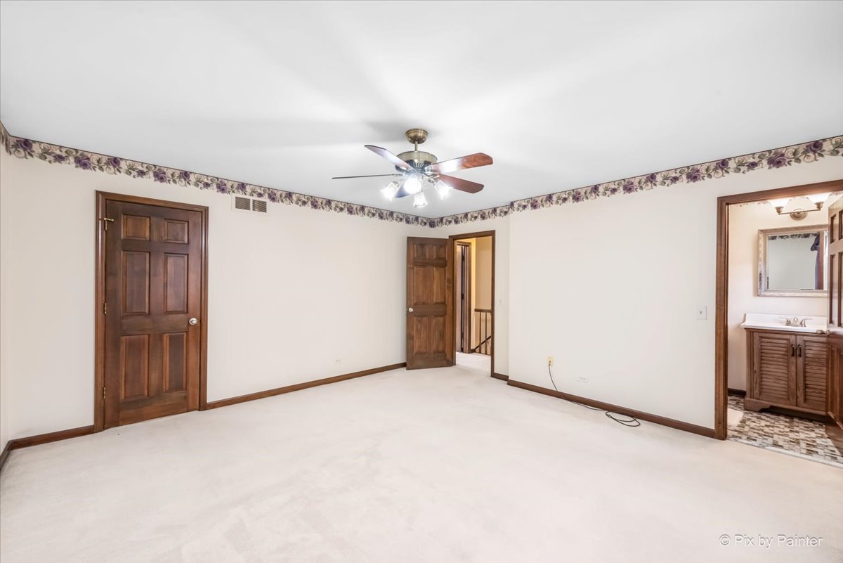 27W650 Mack Road Wheaton, IL 60189 - Photo 14 of 28 a view of a livingroom with a ceiling fan and kitchen space