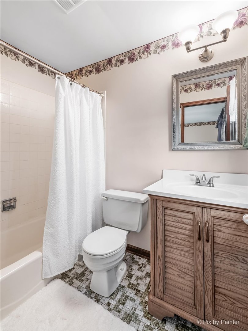 27W650 Mack Road Wheaton, IL 60189 - Photo 15 of 28 a bathroom with a sink a toilet a mirror and shower