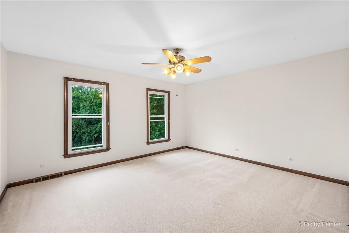 27W650 Mack Road Wheaton, IL 60189 - Photo 16 of 28 an empty room with windows and a ceiling fan