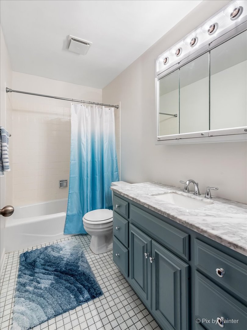 27W650 Mack Road Wheaton, IL 60189 - Photo 17 of 28 a bathroom with a granite countertop sink toilet a mirror and bathtub