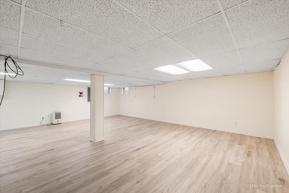 27W650 Mack Road Wheaton, IL 60189 - Photo 21 of 28 an empty room with wooden floor and windows