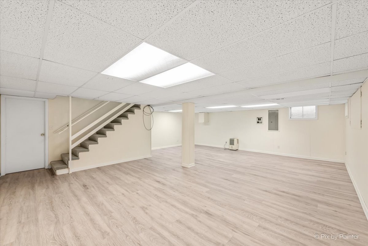 27W650 Mack Road Wheaton, IL 60189 - Photo 22 of 28 an empty room with wooden floor and windows