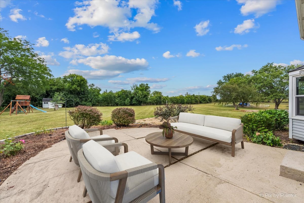 27W650 Mack Road Wheaton, IL 60189 - Photo 23 of 28 a view of a patio with couches potted plants and a big yard