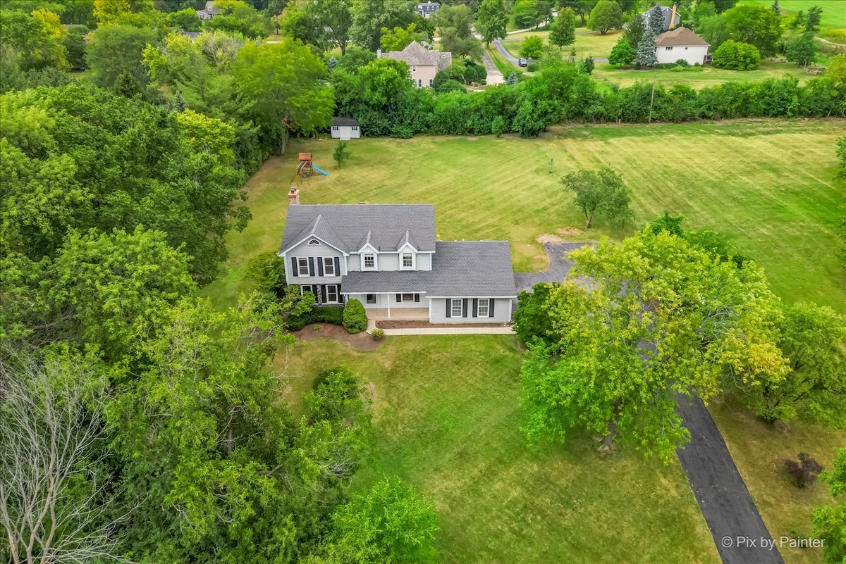 27W650 Mack Road Wheaton, IL 60189 - Photo 26 of 28 a view of a house with a yard and a large tree