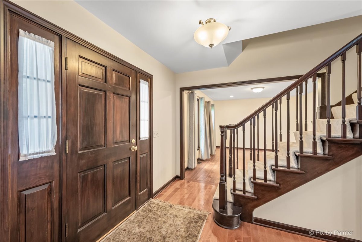 27W650 Mack Road Wheaton, IL 60189 - Photo 3 of 28 a view of entryway with wooden floor and stairs