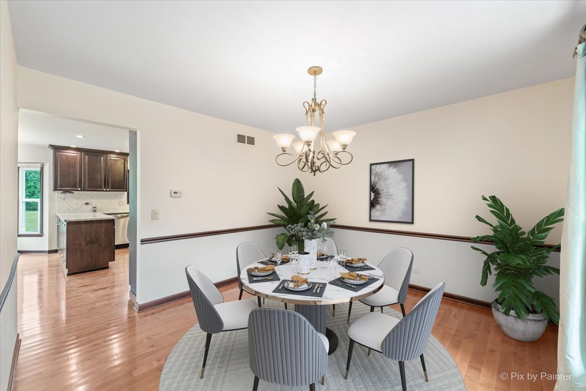 27W650 Mack Road Wheaton, IL 60189 - Photo 5 of 28 a view of a dining room with furniture and wooden floor