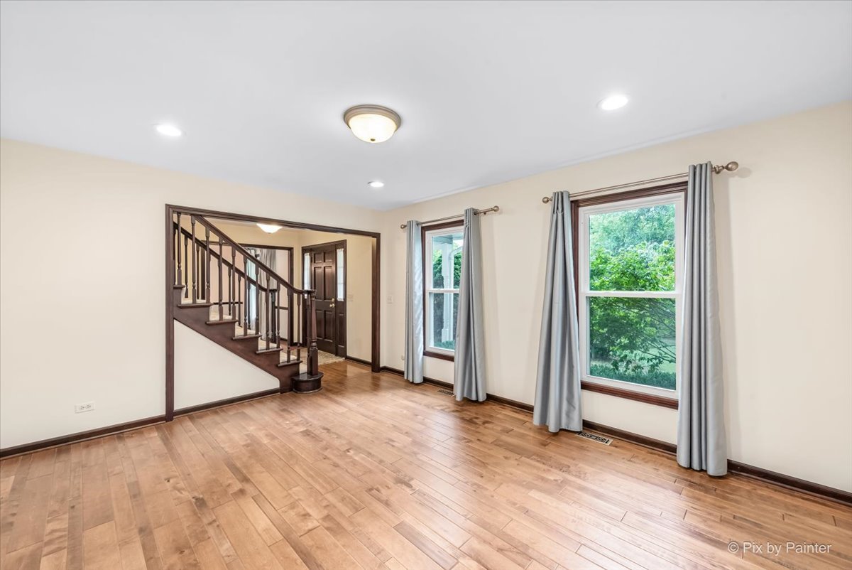 27W650 Mack Road Wheaton, IL 60189 - Photo 7 of 28 an empty room with wooden floor and windows