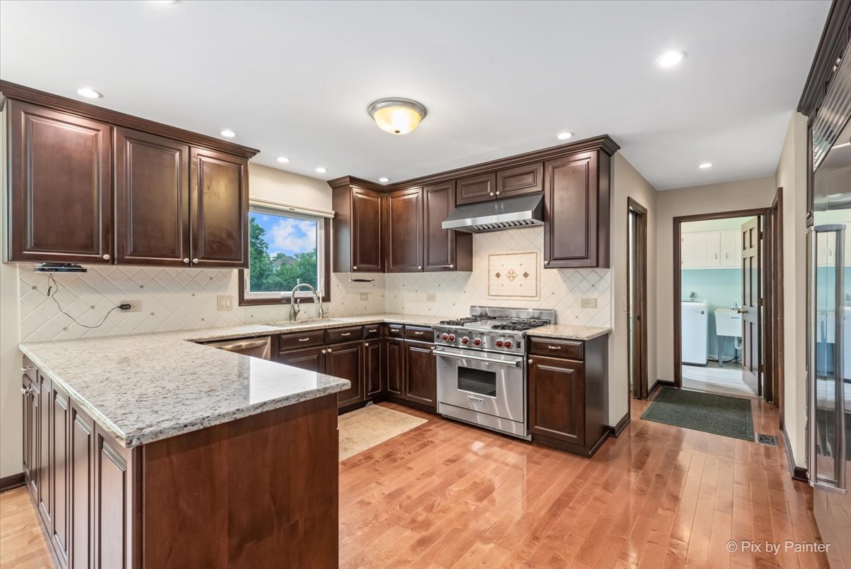 27W650 Mack Road Wheaton, IL 60189 - Photo 8 of 28 a kitchen with stainless steel appliances granite countertop a stove top oven a sink dishwasher a refrigerator and a oven with wooden floors
