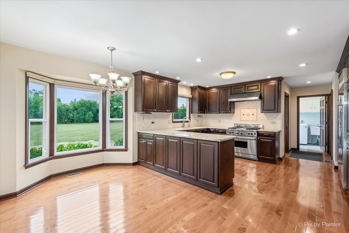 27W650 Mack Road Wheaton, IL 60189 - Photo 9 of 28 a large kitchen with stainless steel appliances granite countertop a stove and a sink