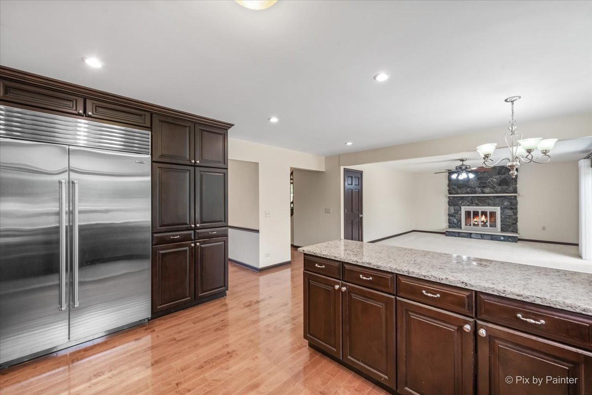 27W650 Mack Road Wheaton, IL 60189 - Photo 10 of 28 a kitchen with granite countertop a refrigerator and a sink