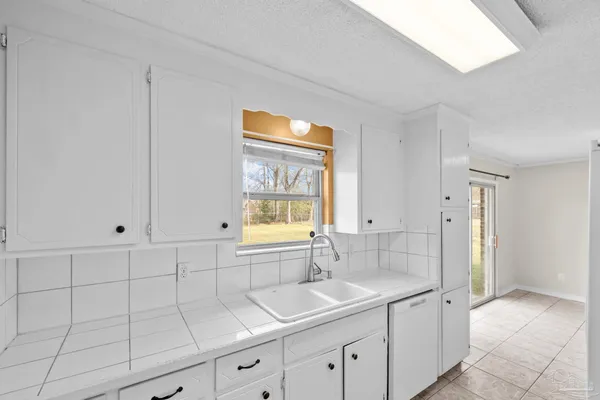 a kitchen with a sink cabinets and window