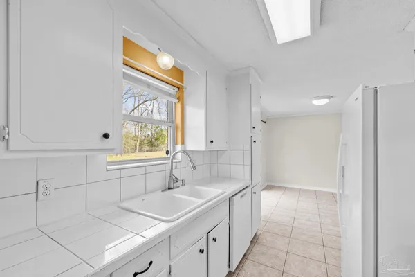 a bathroom with a sink mirror and a bathtub