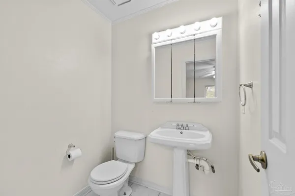 a white toilet sitting next to a bathroom sink