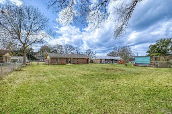 a front view of house with yard and trees
