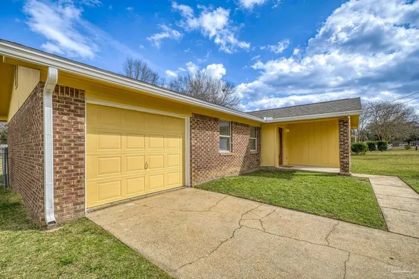 a view of a house with a backyard