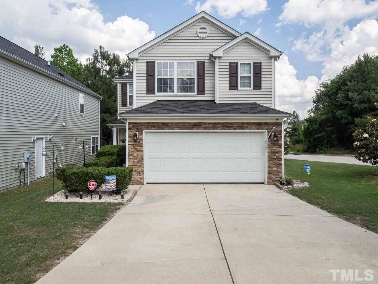 5000 Tommans Trail Raleigh, NC 27616 - Photo 1 of 30 a front view of a house with a yard and garage