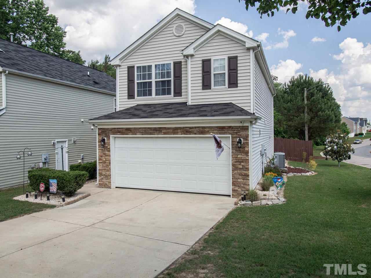 5000 Tommans Trail Raleigh, NC 27616 - Photo 2 of 30 a front view of a house with a yard and garage