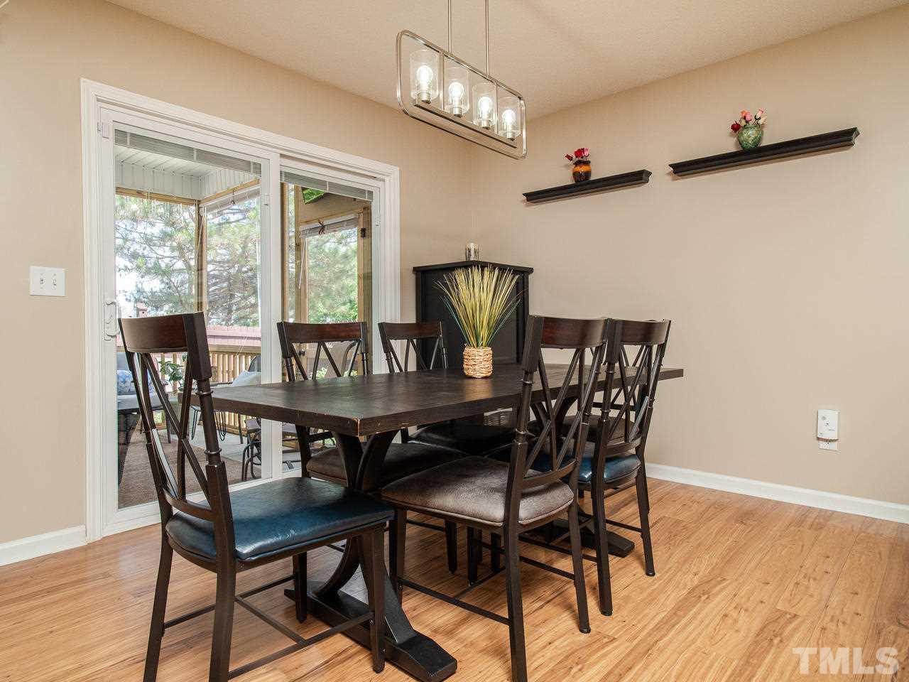 5000 Tommans Trail Raleigh, NC 27616 - Photo 11 of 30 a view of a dining room with furniture window and wooden floor