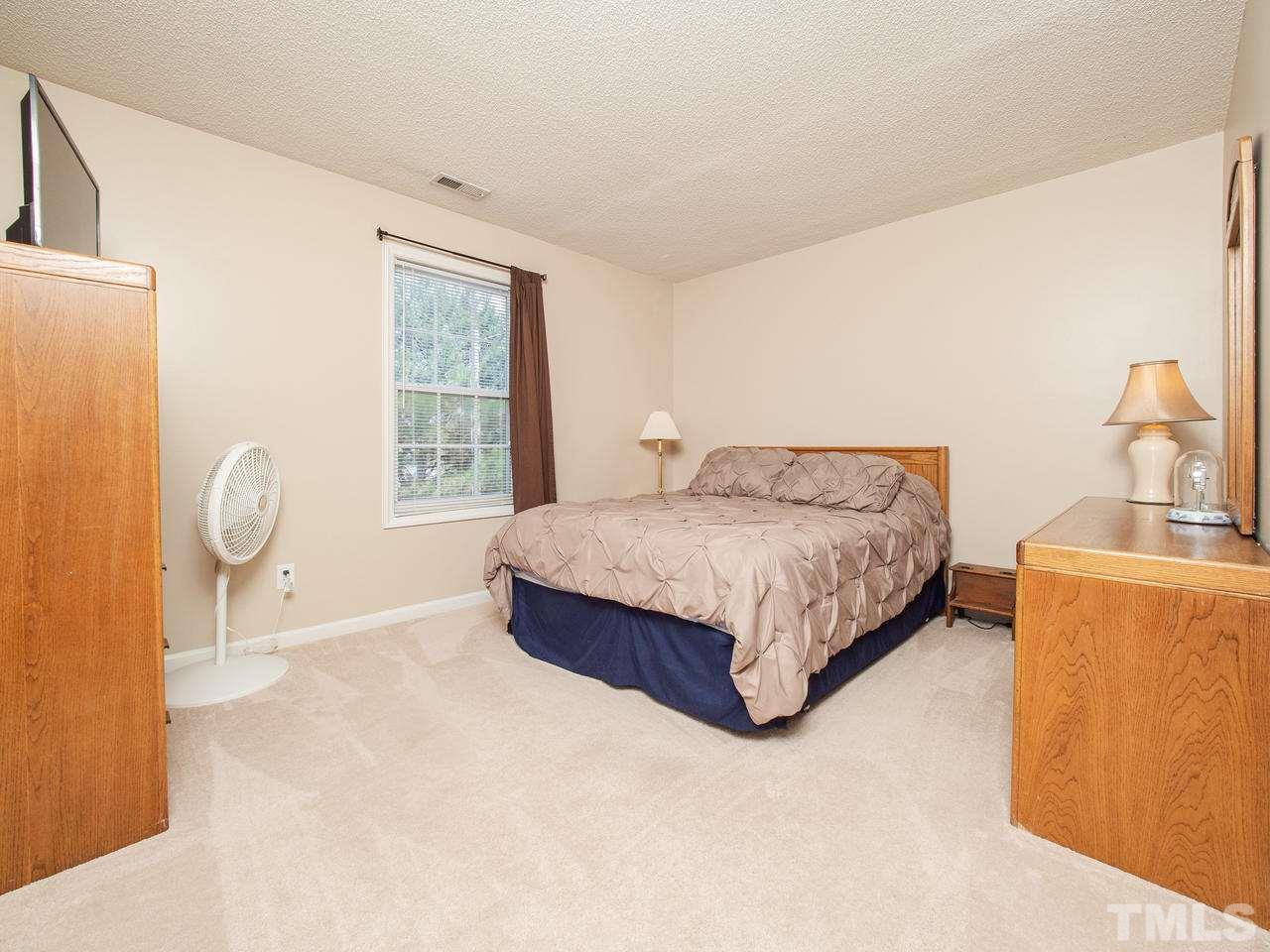 5000 Tommans Trail Raleigh, NC 27616 - Photo 17 of 30 a spacious bedroom with a bed and window