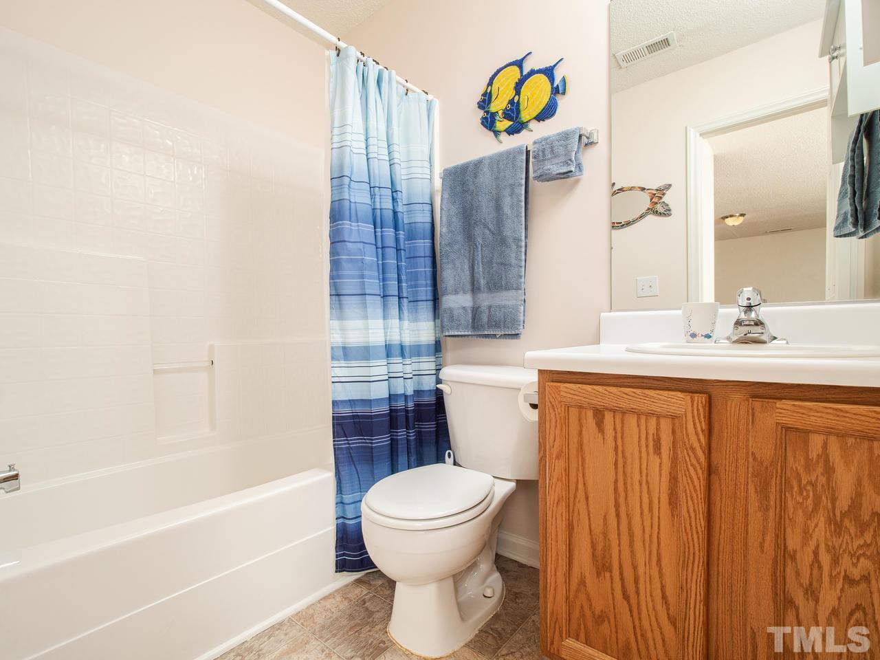 5000 Tommans Trail Raleigh, NC 27616 - Photo 18 of 30 a bathroom with a sink a toilet and shower