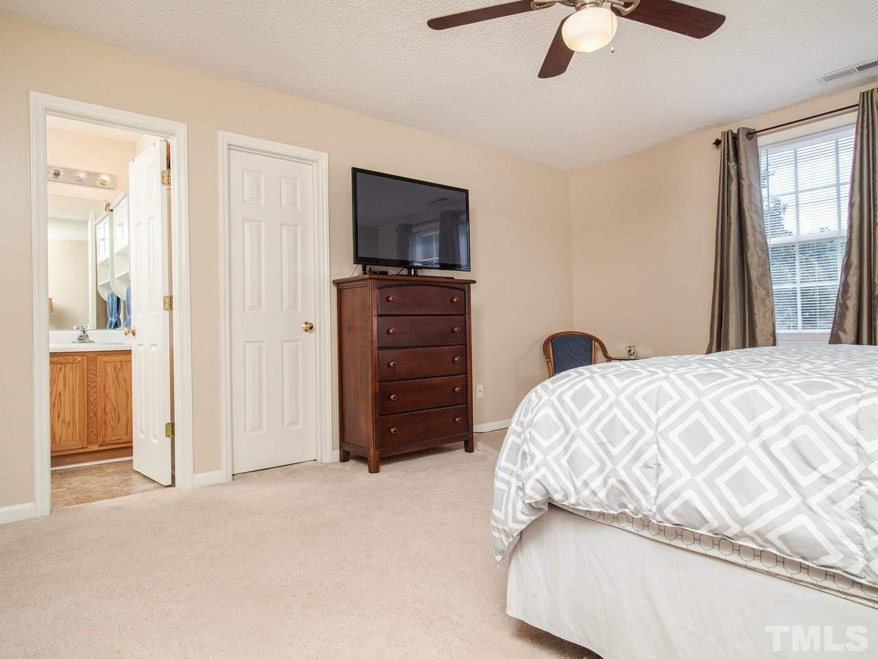 5000 Tommans Trail Raleigh, NC 27616 - Photo 21 of 30 a bedroom with a bed and a television
