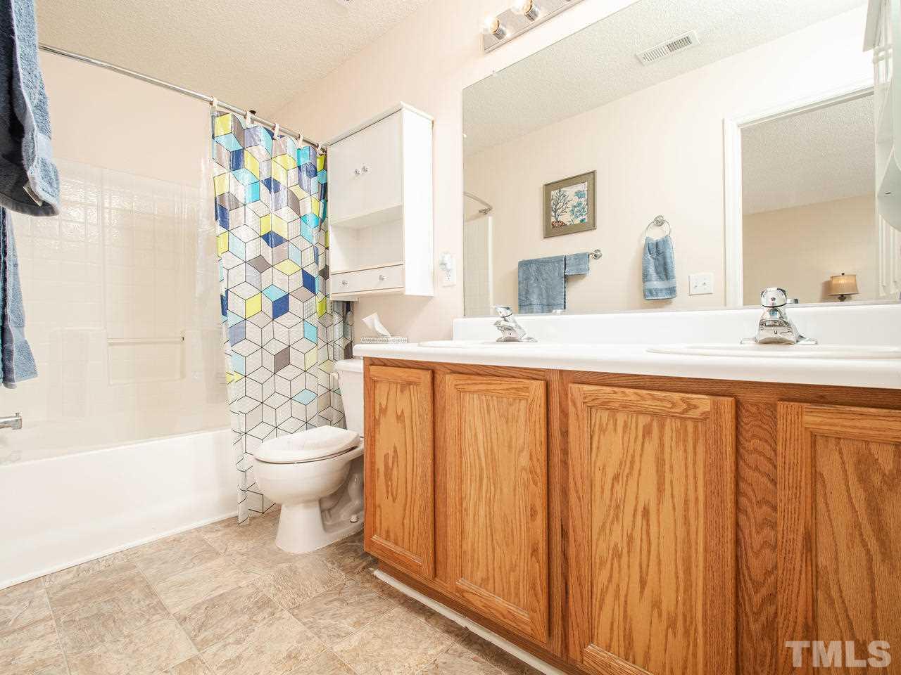 5000 Tommans Trail Raleigh, NC 27616 - Photo 22 of 30 a bathroom with a sink toilet and shower