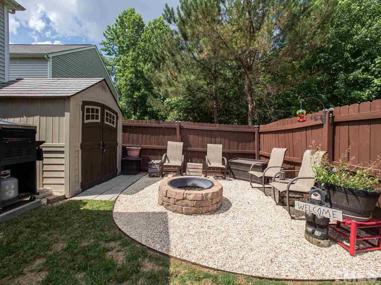 5000 Tommans Trail Raleigh, NC 27616 - Photo 26 of 30 a backyard of a house with fire pit and furniture