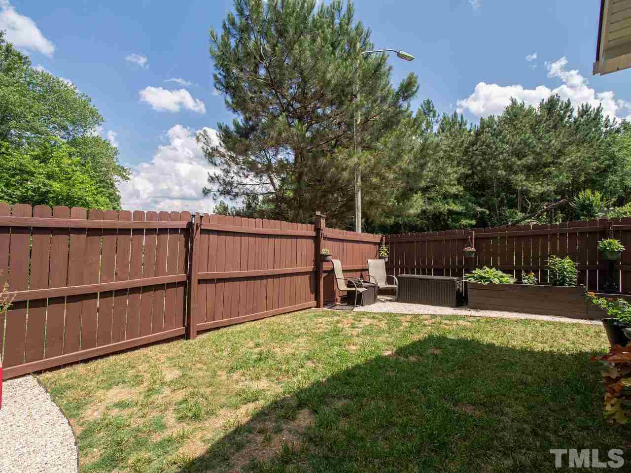 5000 Tommans Trail Raleigh, NC 27616 - Photo 28 of 30 a view of backyard with wooden fence and a bench