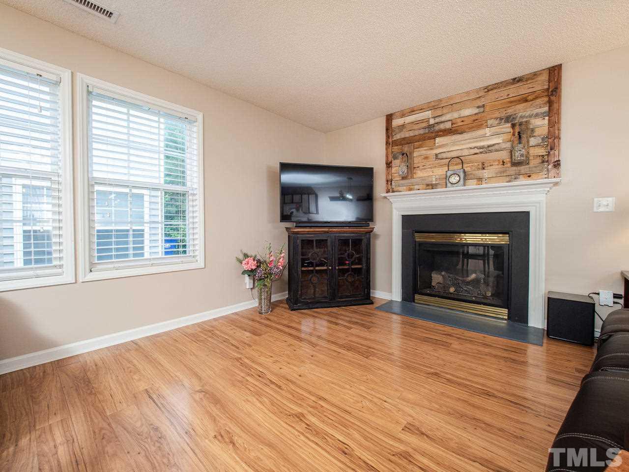 5000 Tommans Trail Raleigh, NC 27616 - Photo 4 of 30 a view of an empty room with a fireplace and a window