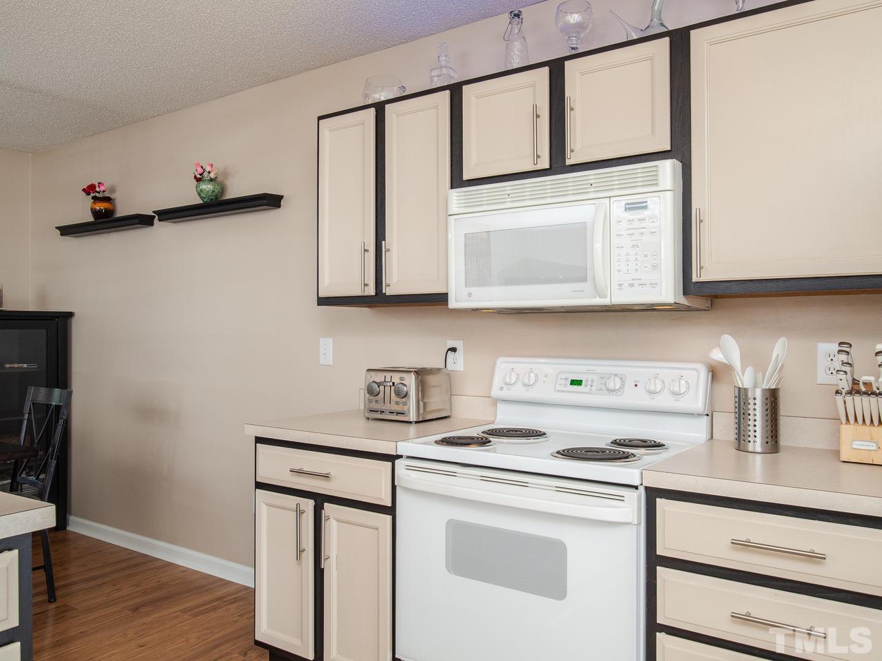 5000 Tommans Trail Raleigh, NC 27616 - Photo 8 of 30 a utility room with stainless steel appliances white cabinets and a stove top oven