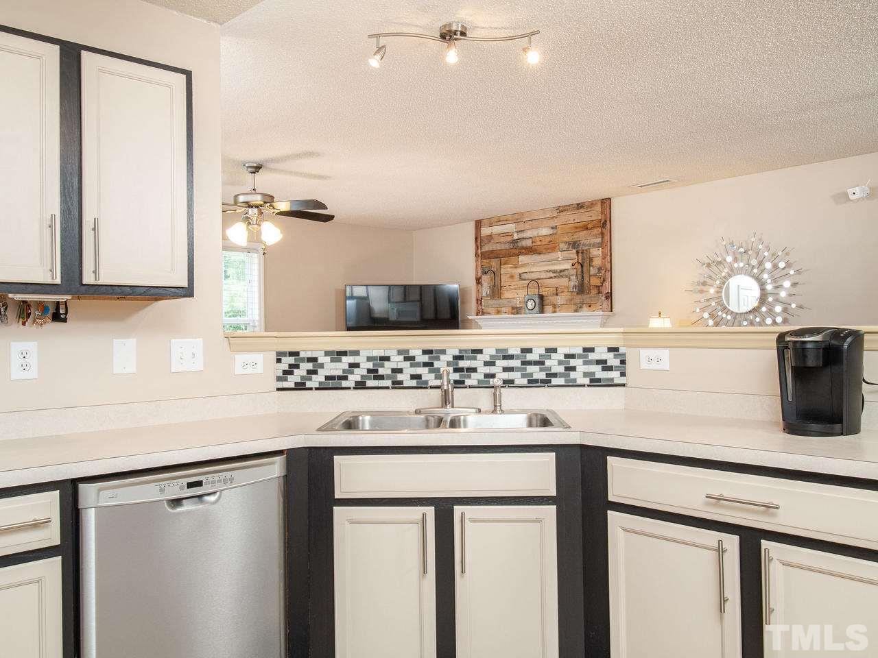 5000 Tommans Trail Raleigh, NC 27616 - Photo 10 of 30 a kitchen with a sink cabinets and window