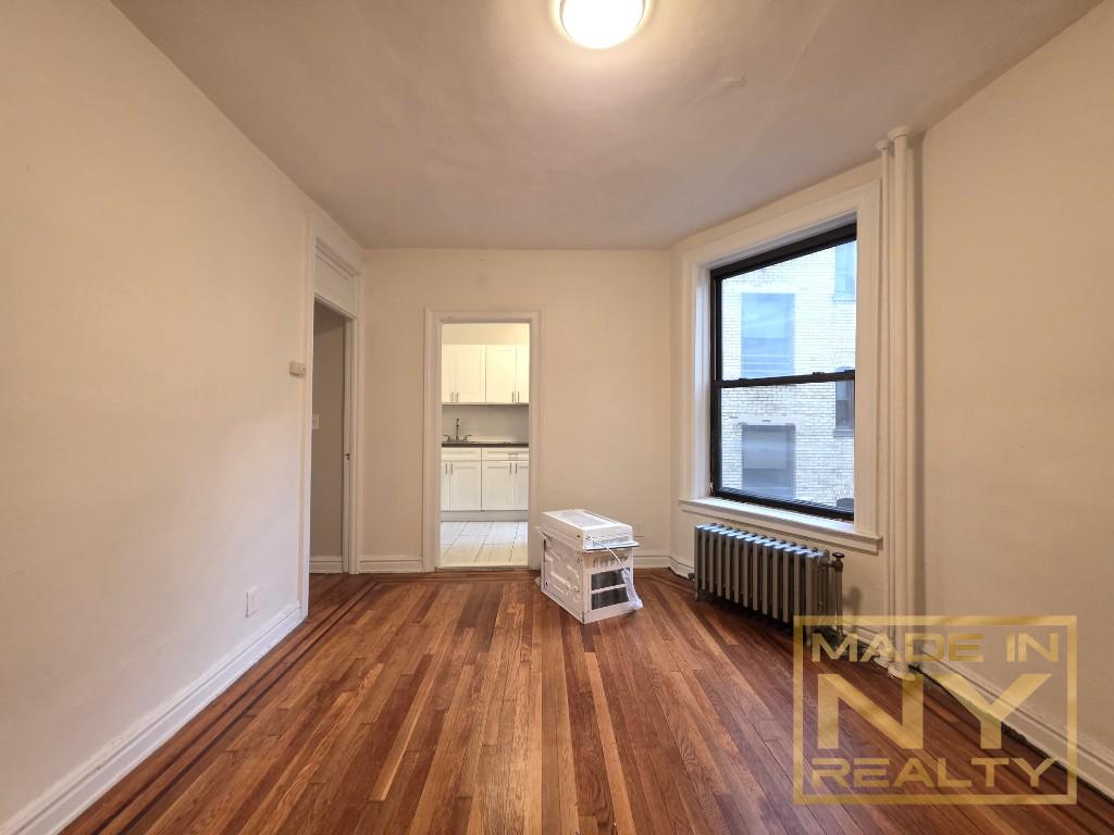 25-21 31st Avenue, Unit A35 Queens, NY 11106 - Photo 3 of 7 a view of a room with wooden floor and windows
