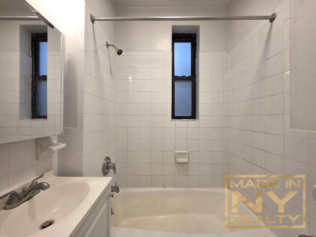 25-21 31st Avenue, Unit A35 Queens, NY 11106 - Photo 5 of 7 a bathroom with a sink and shower