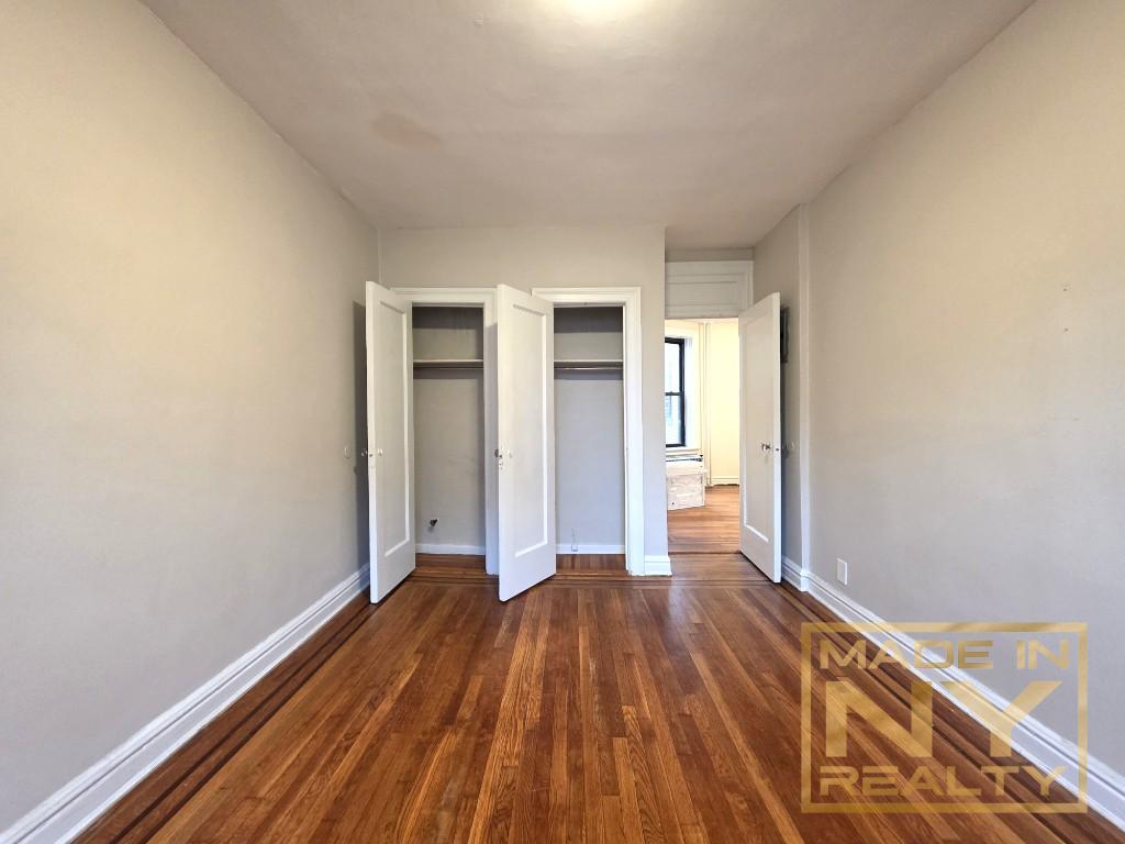 25-21 31st Avenue, Unit A35 Queens, NY 11106 - Photo 7 of 7 a view of a room with wooden floor and a window