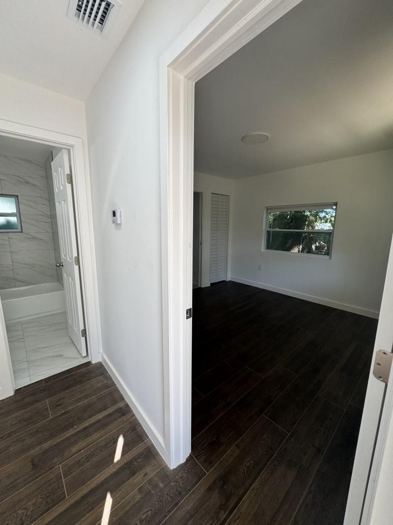 261 Northwest 81st Street, Unit B Miami, FL 33150 - Photo 8 of 12 a view of a hallway view with staircase
