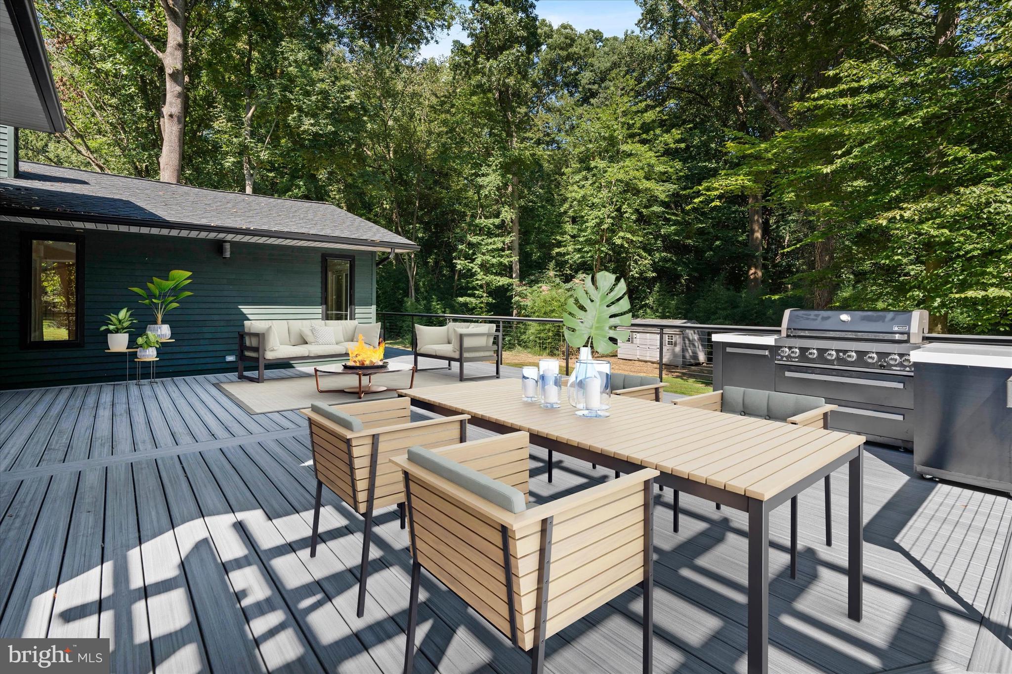 109 1/2 Wayland Road Wilmington, DE 19807 - Photo 34 of 45 a view of a patio with table and chairs a barbeque with wooden floor and fence