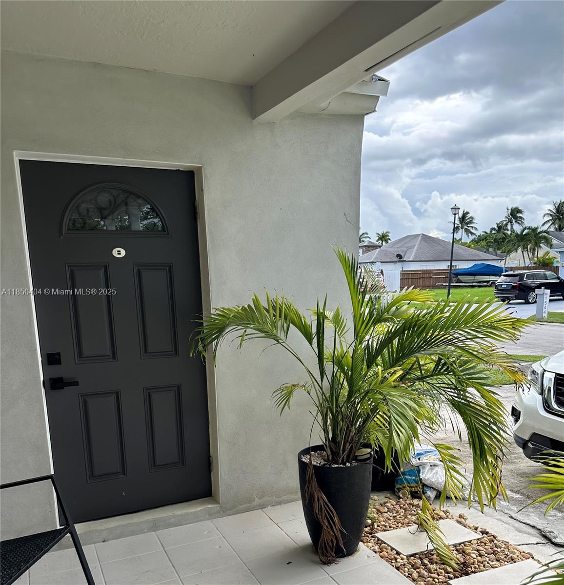 15401 Southwest 144th Avenue, Unit A Miami, FL 33177 - Photo 1 of 6 a vase with flowers sitting on a table in front of a window