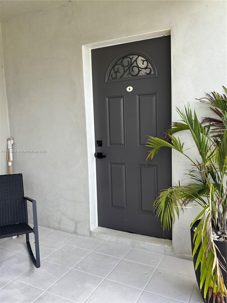 15401 Southwest 144th Avenue, Unit A Miami, FL 33177 - Photo 2 of 6 a view of a door with a potted plant