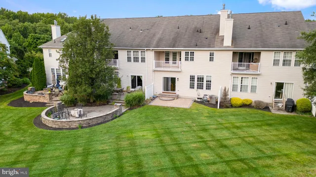 a view of a house with backyard sitting area and swimming pool