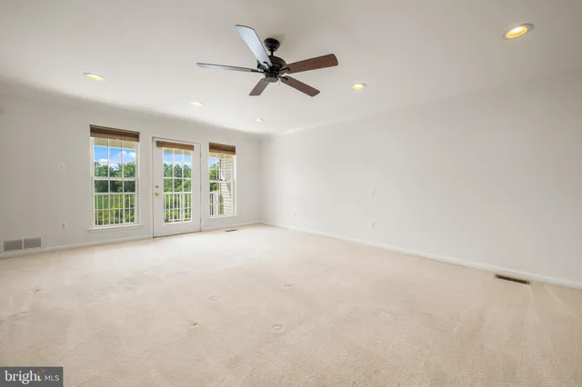 a view of a livingroom with a ceiling fan and window
